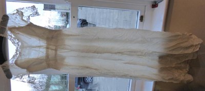 Lot 2077 - Early 20th Century Dresses, comprising a cream silk short sleeved wedding dress with floral...