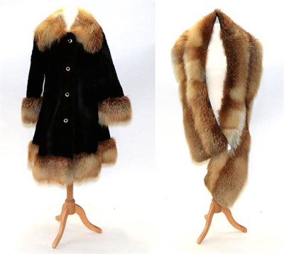 Lot 2199 - A Black Panelled Fur Coat with Fox Fur Trim, to the collar, cuffs and hem, single breasted,...