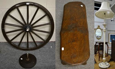 Lot 1079 - A wooden cart wheel with wall mount; an oak low table/stool and a white painted standard lamp (3)