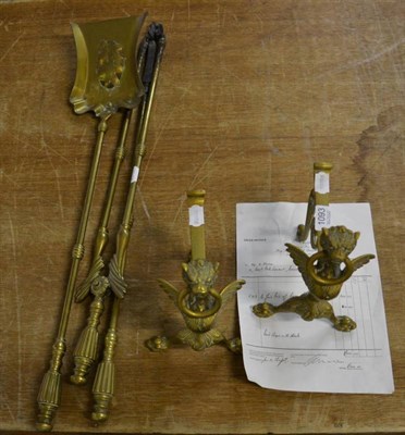 Lot 1093 - A set of three 19th century brass fire irons; and a pair of Griffin andirons