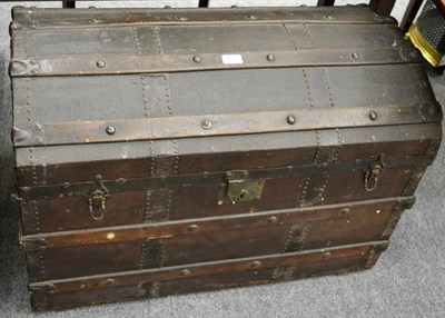 Lot 1123 - A leather and metal bound domed trunk