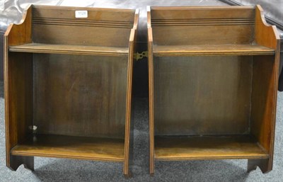 Lot 1128 - A pair of walnut hanging shelves