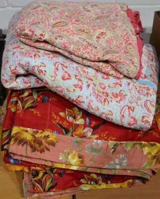 Lot 1147 - Circa 1930s mustard cotton and floral paisley reversible quilt, 170cm by 215cm; pink paisley glazed