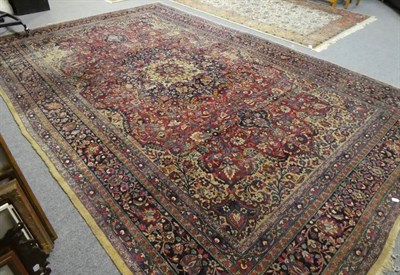 Lot 1160 - A Tabriz carpet, Iranian Azerbaijan, the deep raspberry field of floral vines around an indigo...