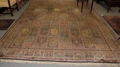 Lot 1172 - Kashmir silk on silk carpet, circa 1960, the polychrome compartmentalised field of Persian...