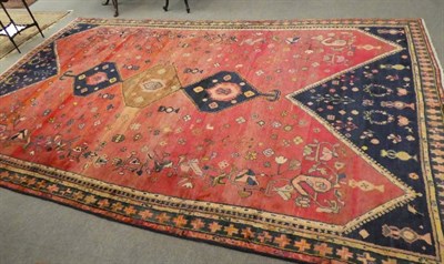 Lot 1173 - A Luri carpet, West Iran, the shaded red field of tribal devices around three stepped...