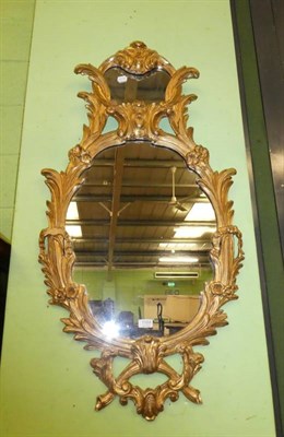 Lot 1184 - A foliate gilt gesso oval wall mirror