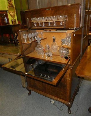 Lot 1198 - A burr walnut drinks cabinet with fall front and fitted interior containing a quantity of cut table