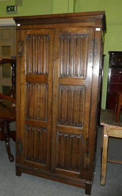 Lot 1201 - An oak linen fold wardrobe