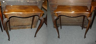 Lot 1202 - A pair of carved serpentine fronted console tables