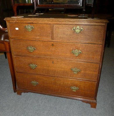 Lot 1205 - An oak straight fronted four height chest of drawers