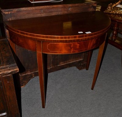 Lot 1224 - A line inlaid demi-lune mahogany foldover card table