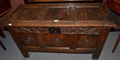 Lot 1225 - A small panelled oak coffer with foliate carved frieze