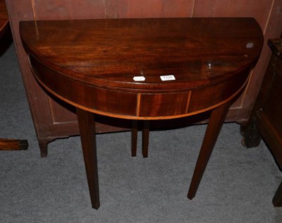 Lot 1226 - A mahogany demi lune fold over tea table