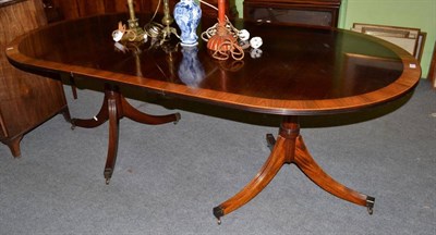 Lot 1227 - A crossbanded mahogany twin pedestal dining table on reeded supports, by Millwood Cabinet Making