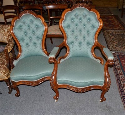 Lot 1240 - A large Victorian carved walnut armchair in green and a matching ladies chair