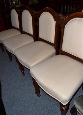 Lot 1245 - A set of four carved mahogany dining chairs upholstered in cream fabric