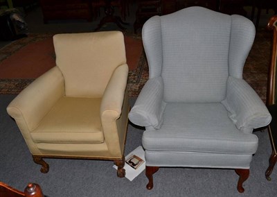 Lot 1251 - A duck egg blue upholstered wing back armchair, together with a 1920s armchair on ball and claw...