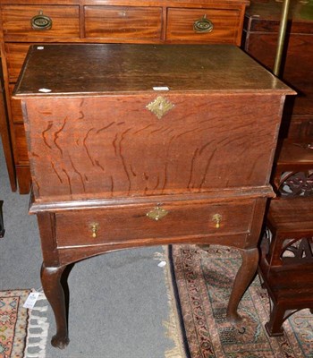 Lot 1254 - An 18th century oak box on stand, the hinged lid above a moulded base with single frieze drawer and