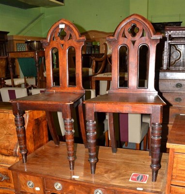 Lot 1259 - A pair of mahogany Gothic style hall chairs