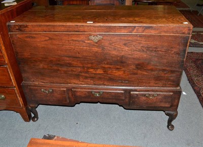 Lot 1261 - A George III elm chest on stand, late 18th/early 19th century, with hinged lid and side...