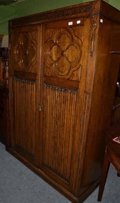 Lot 1275 - A carved and linen fold hall cupboard/wardrobe