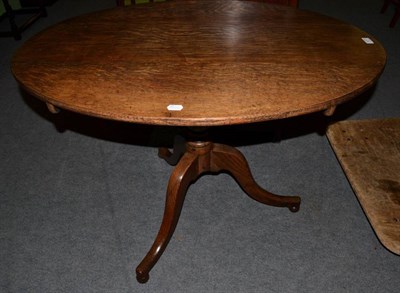 Lot 1277 - A George III oval topped oak tilt top tripod table