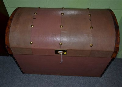 Lot 1282 - An early 20th century leather and brass studded dome top trunk, labelled from Brick Brothers,...