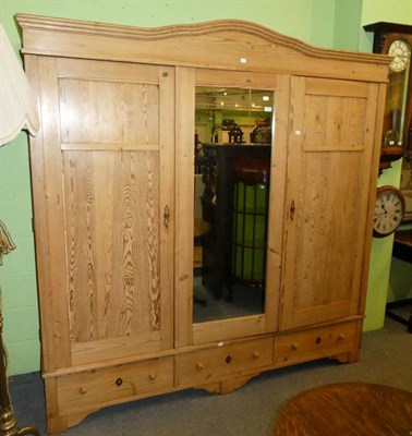 Lot 1287 - Pine triple door wardrobe with central mirror panel