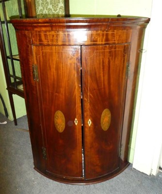 Lot 1295 - A Georgian bow fronted corner cupboard