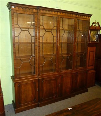 Lot 1300 - A Bevan Funnell reproduction mahogany breakfront bookcase cabinet