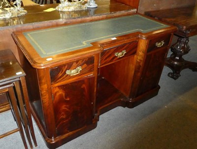 Lot 1303 - A Victorian mahogany inverted breakfront desk, late 19th century, with gilt leather inset...