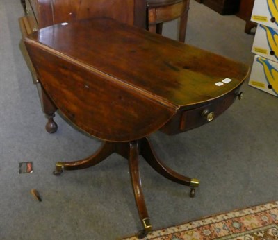 Lot 1305 - A 19th century mahogany oval top drop leaf pedestal table