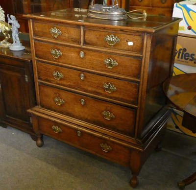 Lot 1306 - A Georgian oak chest on later stand