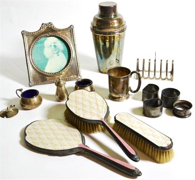 Lot 11 - Assorted silver to include a photograph frame; an enamel part dressing table set; a toastrack...