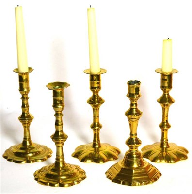 Lot 34 - Two pairs of 18th century brass candlesticks and another single example (5)