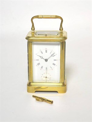 Lot 42 - A brass striking and repeating alarm carriage clock, twin barrel movement striking on a bell, later