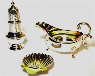 Lot 52 - A silver sauce boat, Pinder Brothers, Sheffield 1975, with gadroon rim; a silver caster C J Vander
