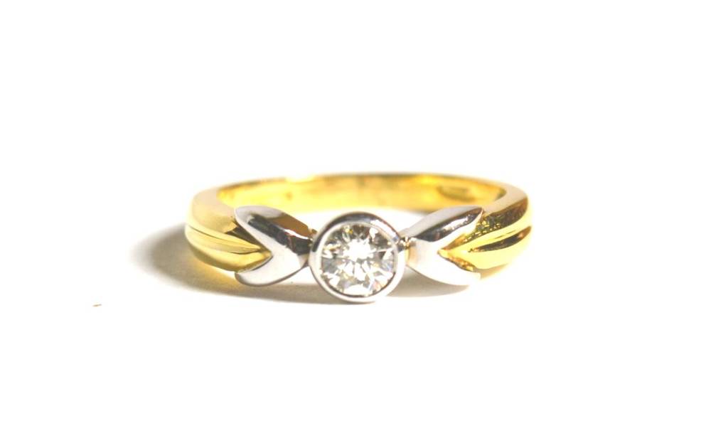 Lot 69 - An 18 carat gold solitaire diamond ring, a round brilliant cut diamond in a rubbed over setting, to