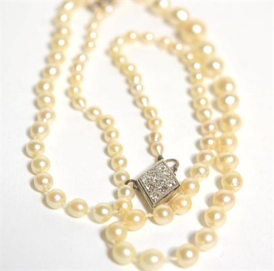 Lot 70 - An early 20th century graduated cultured pearl necklace, with a lozenge shaped diamond set...
