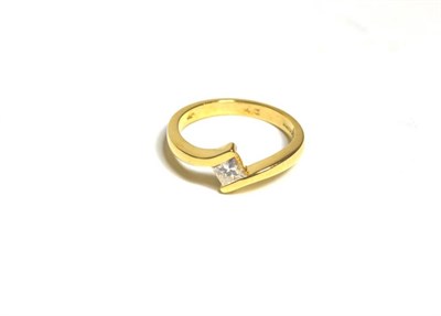 Lot 76 - An 18 carat gold solitaire princess cut diamond ring, in a tension bypass setting, estimated...