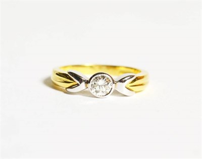 Lot 91 - An 18 carat two colour gold solitaire diamond ring, a round brilliant cut diamond in a rubbed...
