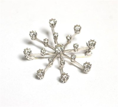 Lot 108 - A diamond snowflake brooch/pendant, a central round brilliant cut diamond in a claw setting to...