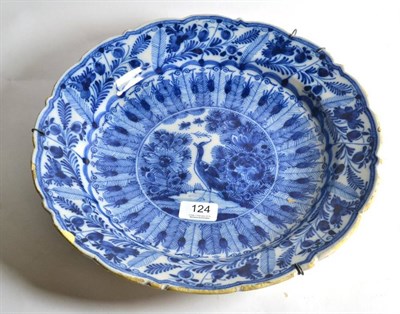 Lot 124 - A Dutch Delft charger decorated with a peacock pattern, initials to reverse, 34.5cm diameter