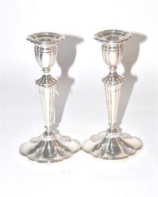 Lot 137 - A pair of modern cast silver candlesticks, C J Vander, Sheffield 1996, fluted on shaped oval...