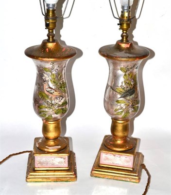 Lot 140 - A pair of gilt and decalcomania table lamps