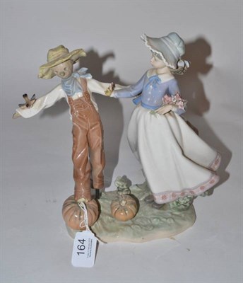 Lot 164 - A Lladro girl and scarecrow figure