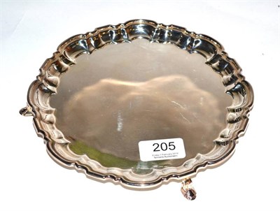 Lot 205 - A silver card tray, C J Vander, Sheffield 2005, shaped circular on pad feet, 20cm diameter, 10.5ozt