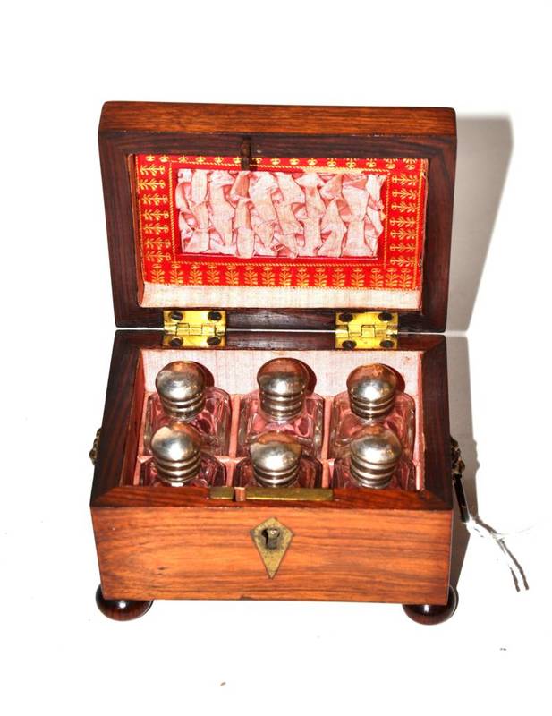 Lot 206 - A perfume casket with twin lion mask drop ring handles, on four ball feet, the fitted interior...