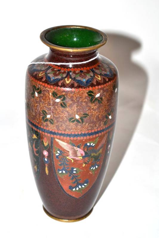 Lot 207 - An enamel baluster vase with shield shaped panels containing dragons on a light brown...